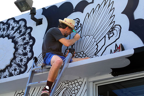 Artist Carl Janes at work on a 24th Street mural