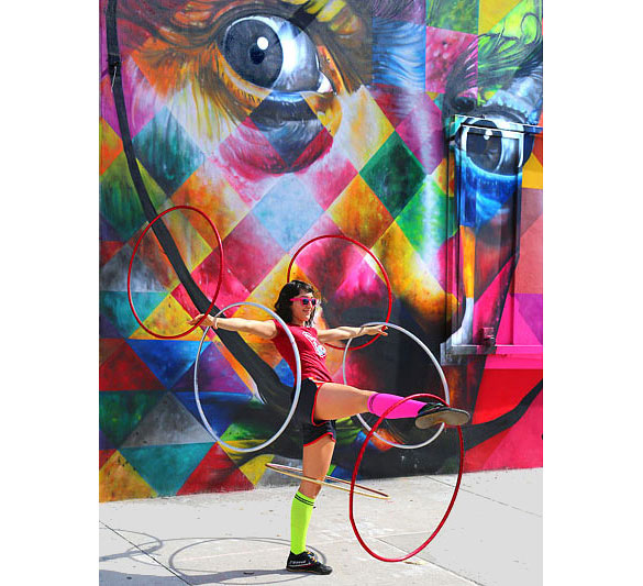 Street performer in front of a “Kobra” mural