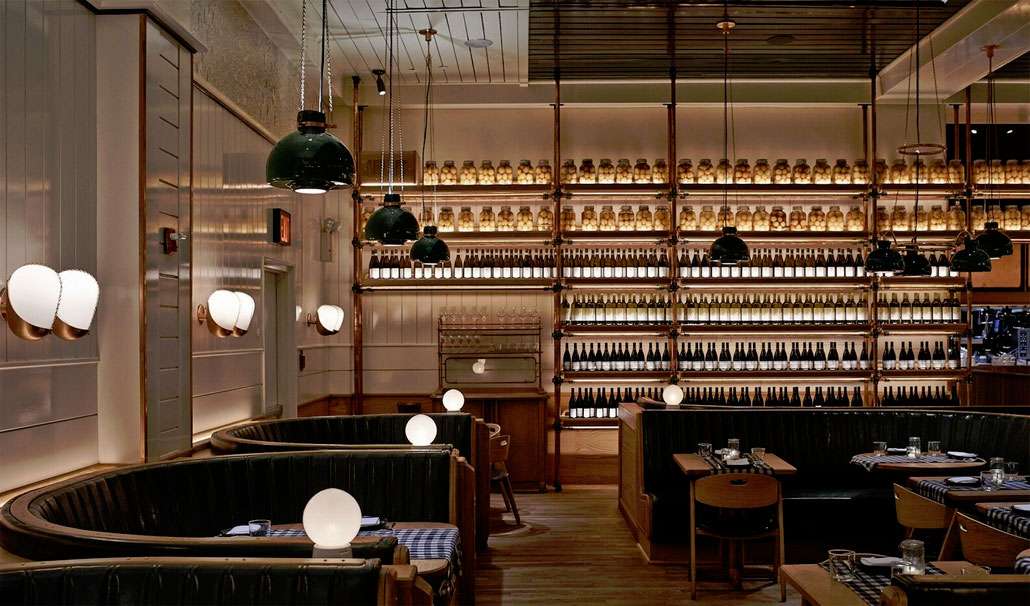 Awash in the glow of backlit bottles of wine and preserved citrus, Upland's dining room dazzles