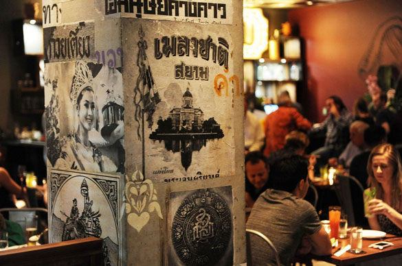 NaiYaRa Restaurant boasts an ecclectic mix of vintage Thai posters, reclaimed wood tables and rich red banquettes