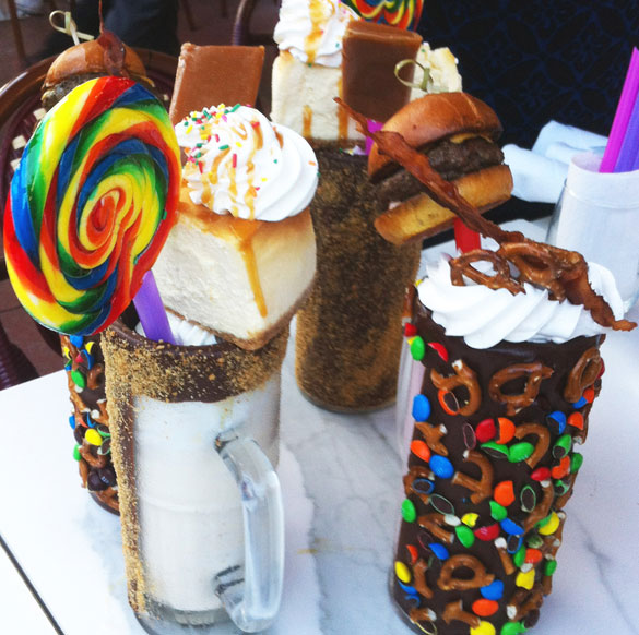 Choose from a variety of freshly whipped milkshakes served in chocolate candy-coated mugs and topped with mini burgers and sweets
