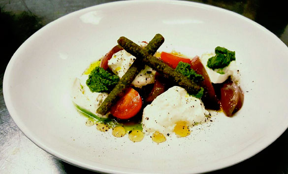 Heirloom Tomato Salad with ramp pesto, burrata, and basil churros