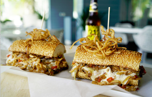 Chef Bernie Matz's Shaved Rib Eye with Jalapeno Jack Whiz, Provolone, Sofrito, Crispy Onions on a Sesame Baguette