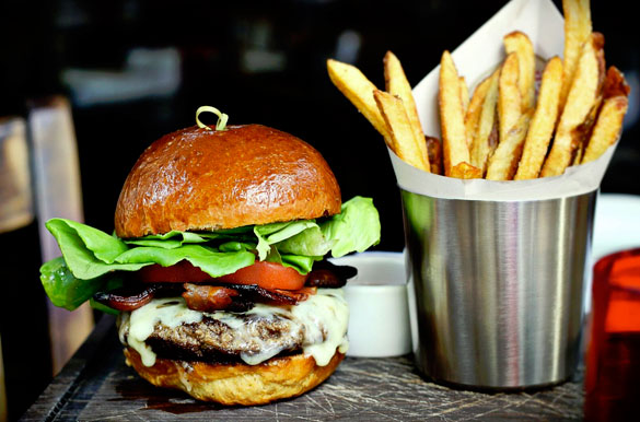 Chef de Cuisine Saul Ramos' Genuine Burger with bacon & cheddar at Michael's Genuine Food & Drink (photo courtesy of MGFD Hospitality)