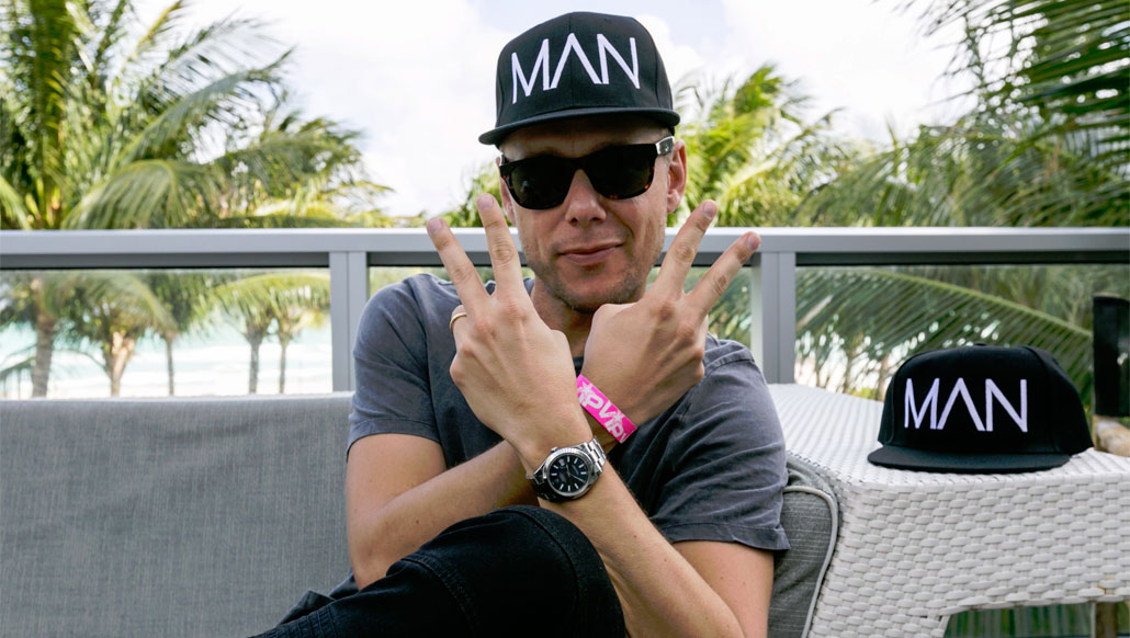 Armin Van Buuren tries on Boohoo’s MAN cap at The Music Lounge by iHeartMedia + BMF Media